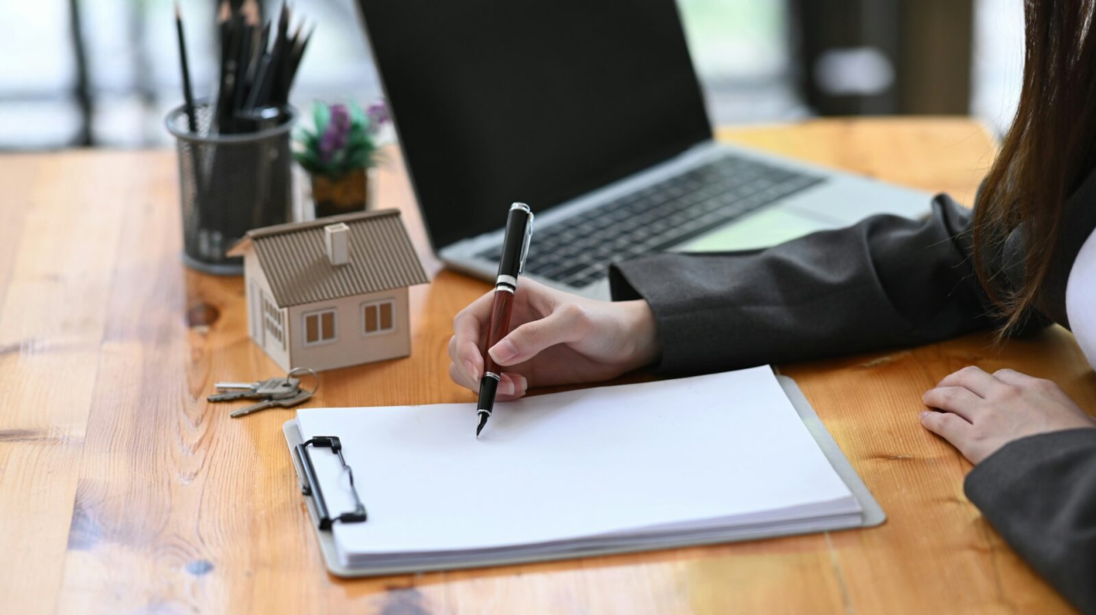 Mortgage adviser explaining the benefits of porting a mortgage to a couple moving to a new home