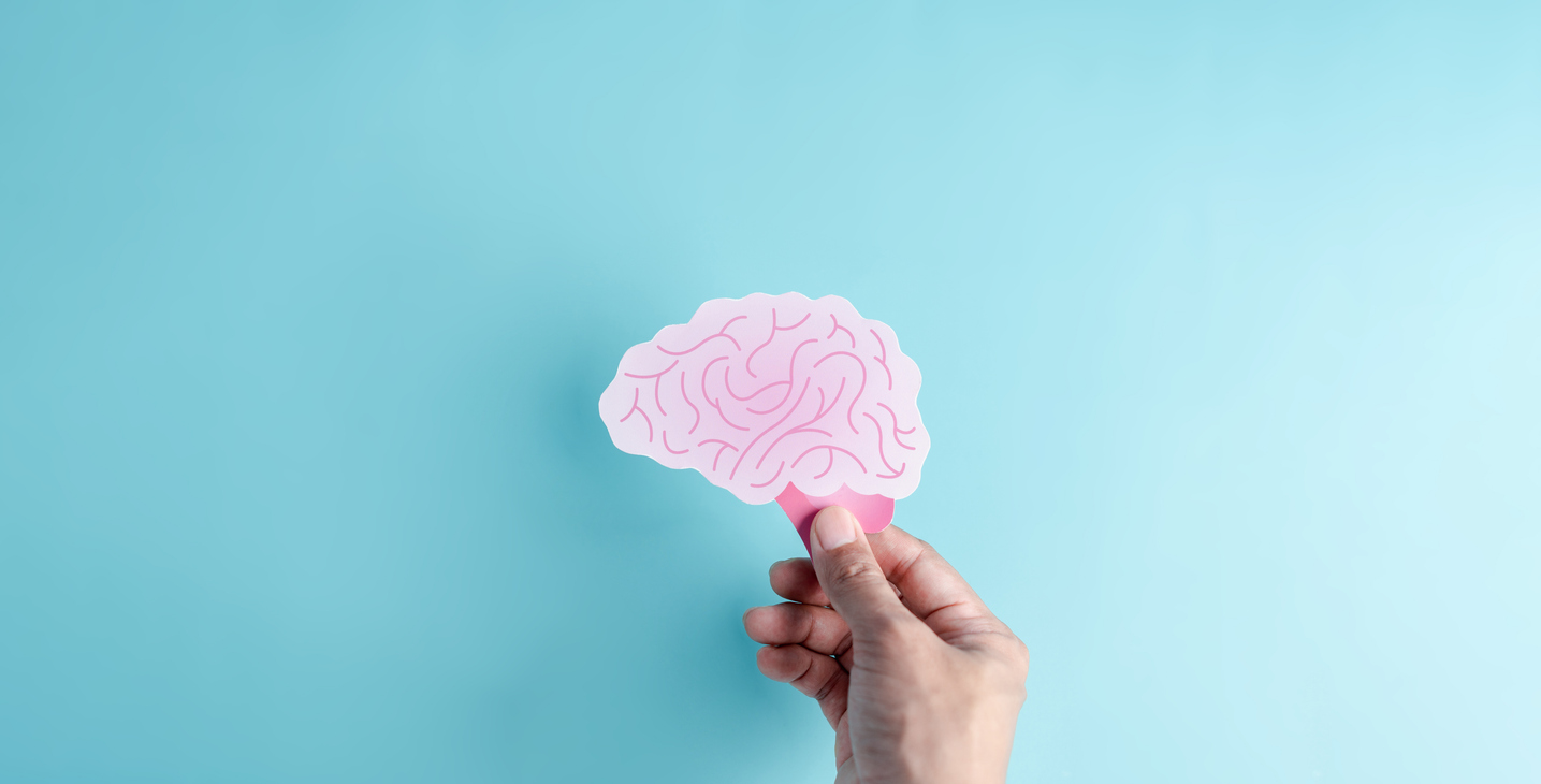 A paper model of a brain, crafted with intricate folded paper layers, representing the concept of neurodiversity and the diverse, layered structure of human cognition.